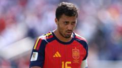 Spain national team footballer wearing a red jersey with number 15 on the field during a match, focused on the play.
