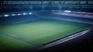 cover-9271-1787014838jpg - 實發體育 Nighttime view of a large football stadium with a well-lit green pitch and surrounding stands.