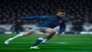 Soccer player in a blue jersey sprinting on a green field, motion blur behind him.